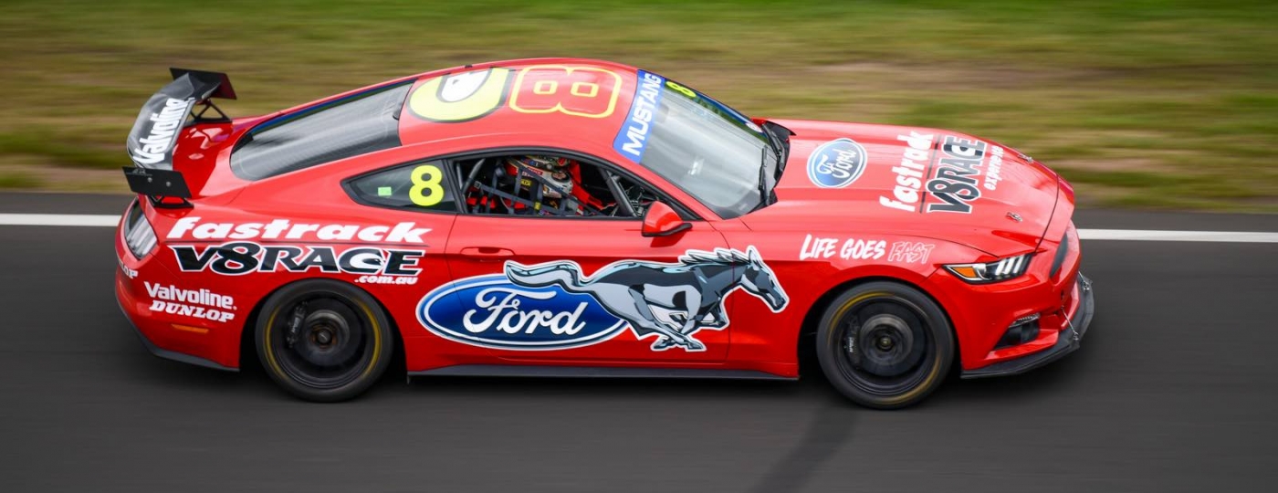red mustang race car on a race track