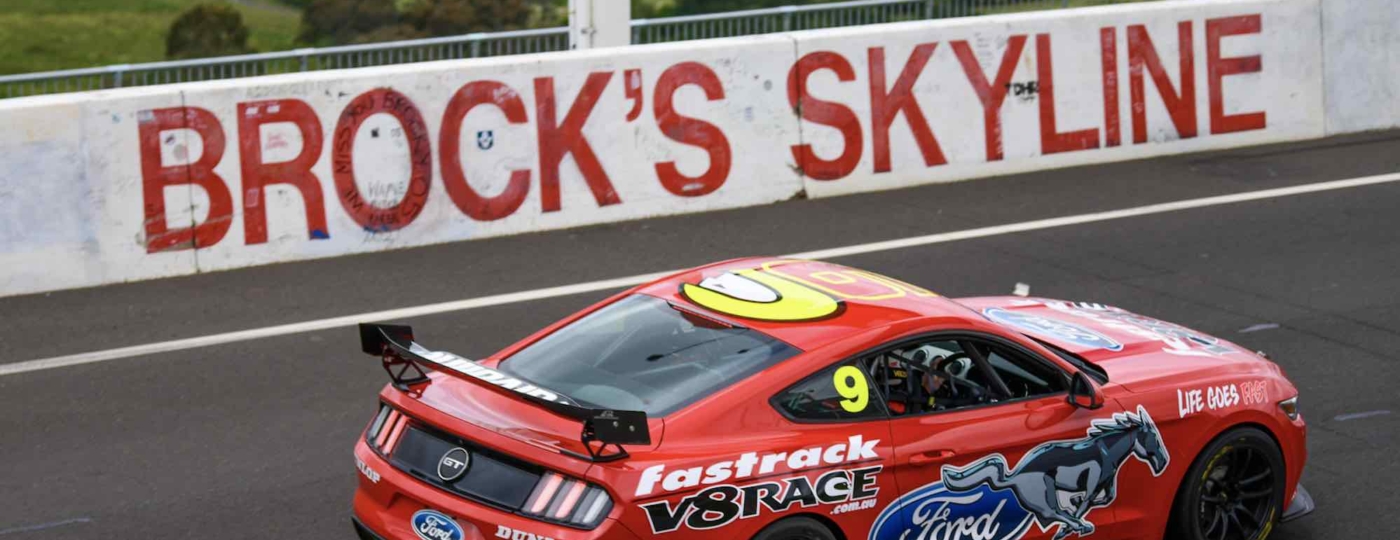 red race car on the track at mount panorama