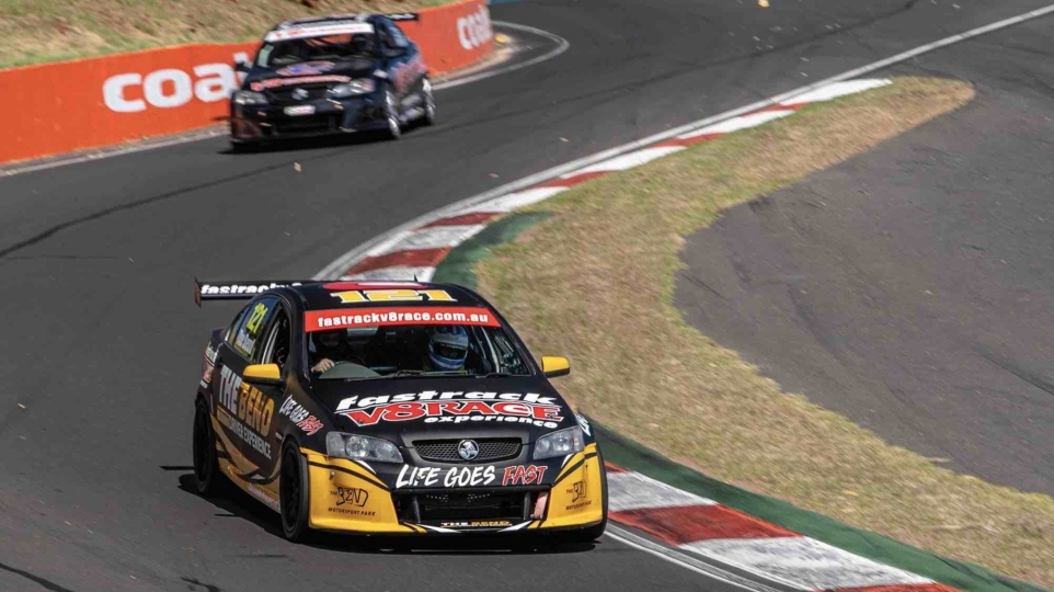 v8 race cars racing around the track