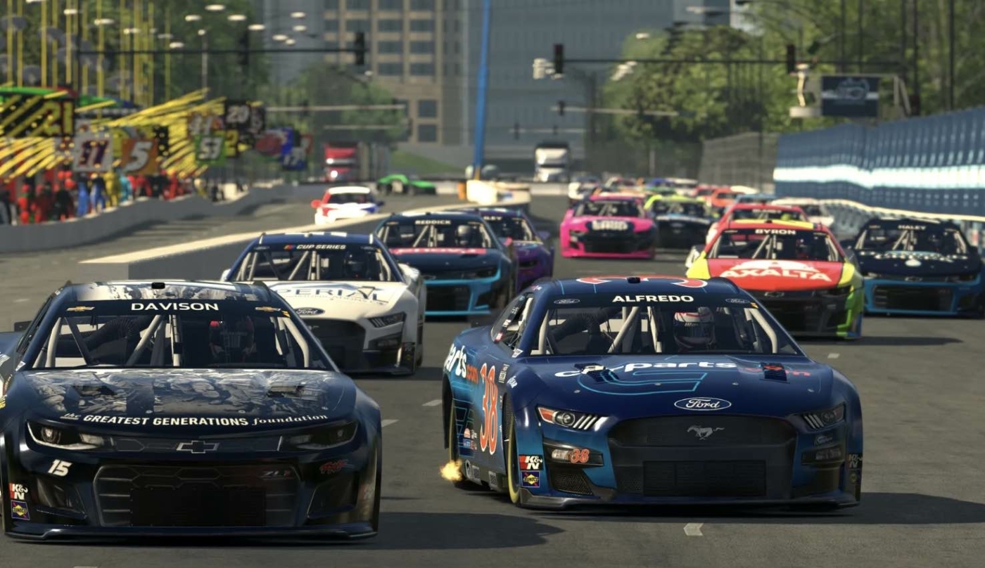 race cars driving around the track during a race